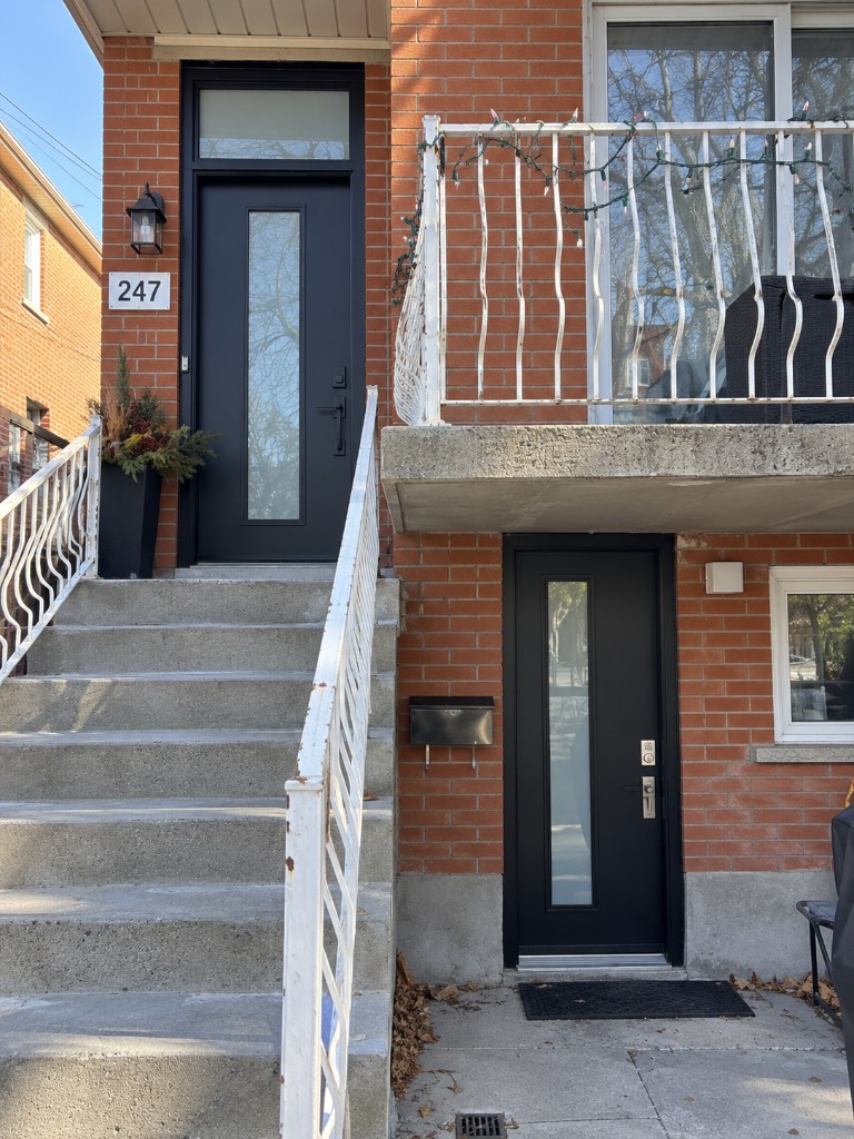 Black entry doors on a brick home