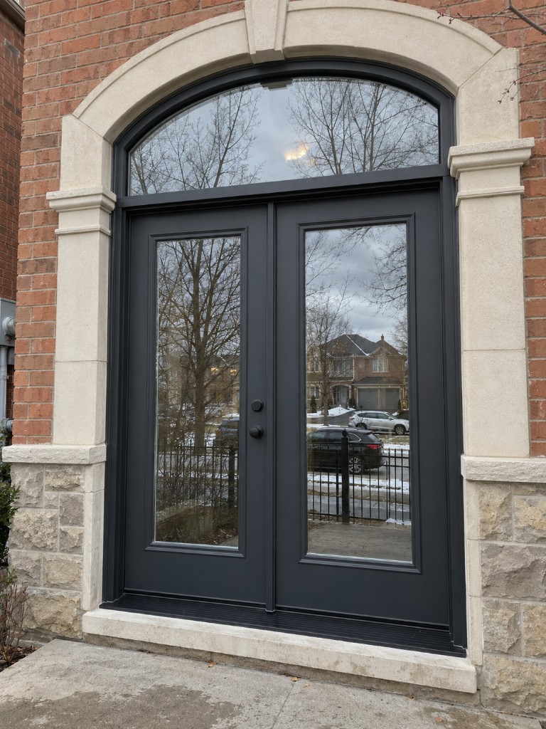Black double doors with an arched transom