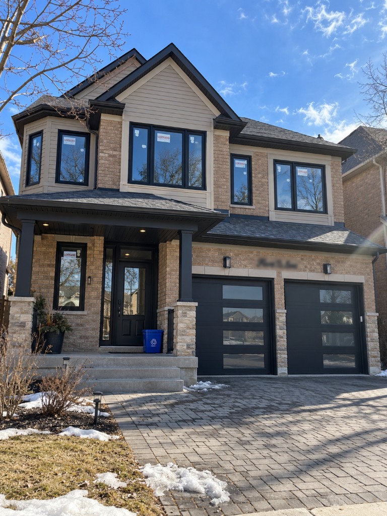 Brick home with new windows, entry, and garage doors